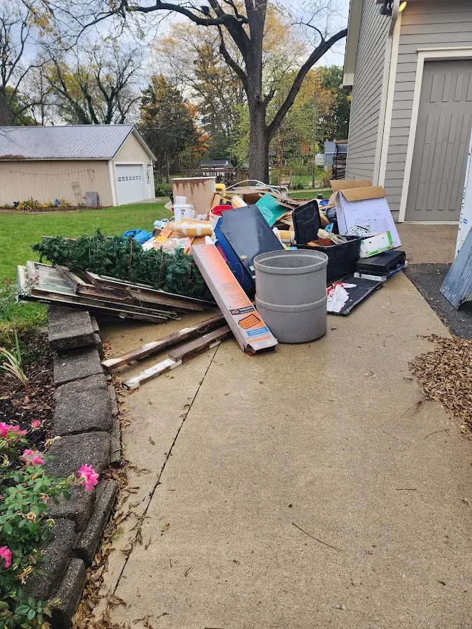 Dumpster being loaded with debris for Commercial Dumpster Rental in Carroll Valley